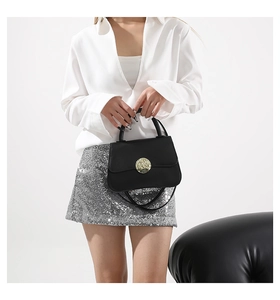 Chic black mini crossbody bag with golden round buckle shown on a white background