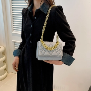 Elegant pearlescent silver crossbody bag with quilted pattern and gold chain strap