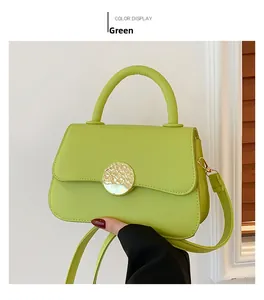 Detail of neon green crossbody bag with textured gold buckle and premium smooth leather