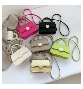 Detailed macro view of colorful mini crossbody bags with metallic turn-lock closure