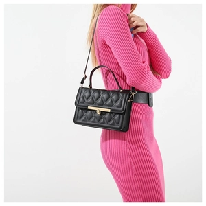 Chic black quilted crossbody bag with gold hardware worn on a pink knit dress
