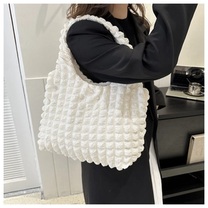 Detailed view of white bubble texture tote bag showing soft quilted nylon fabric on shoulder