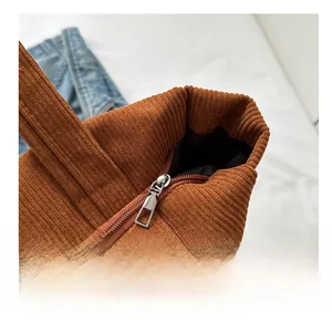 Macro detail of silver metal zipper on vintage caramel corduroy tote bag fabric