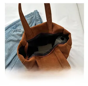 Spacious brown corduroy tote bag showing interior capacity with a zipper closure