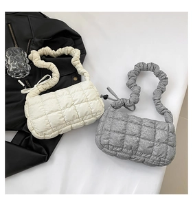 Top view of quilted square shoulder bags in cream and glitter silver with ruched straps