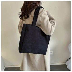 Minimalist black corduroy tote bag for women showing a spacious retro shoulder carry design
