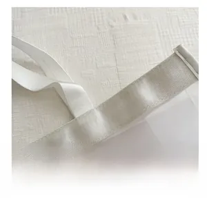 Close-up of reinforced stitching on white mesh tote bag straps and nylon webbing