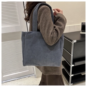 Detail of blue corduroy tote bag showing spacious design and soft ribbed fabric texture