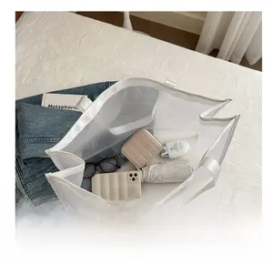 Internal view of a white mesh tote bag showing capacity with umbrella and phone
