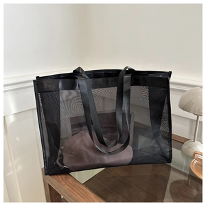 Detail of black mesh tote bag showing spacious interior and semi-transparent mesh texture