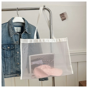 Detail of white mesh tote bag showing transparent texture and spacious storage capacity
