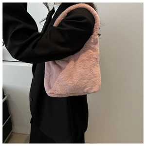 Pink plush faux fur underarm bag styled with a black blazer for a chic spring look