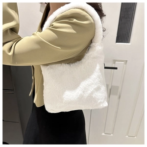 Detail of soft white plush shoulder bag with smooth zipper on a khaki blazer outfit
