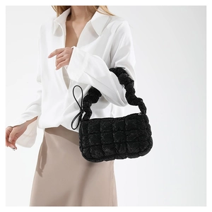 Quilted black puffer hobo bag with ruffled handle and textured checkerboard pattern