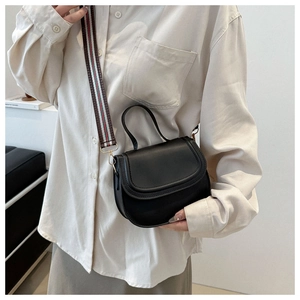 Fashionable black leather saddle bag with colorful striped canvas wide shoulder strap