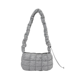 Silver quilted shoulder bag with shiny metallic finish and ruched cloud handle