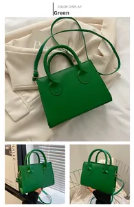 Detail view of stylish green matte PU leather square bag with gold metal buckles and strap