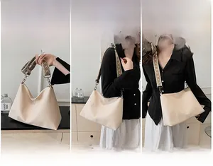 Detailed views of cream tote bag featuring an ethnic style embroidered wide strap