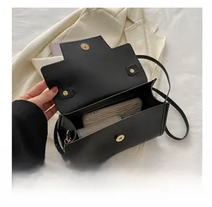 Detail view of the black matte suede crossbody bag interior with card slots and storage space