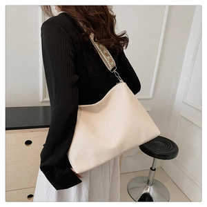 Detail of off-white tote bag with vintage geometric patterned wide shoulder strap