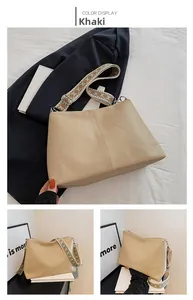Detail view of khaki bucket bag with lychee texture and ethnic geometric wide strap