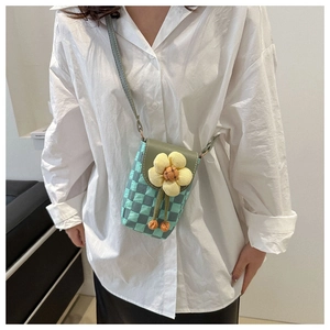 Green checkerboard pattern mini crossbody bag featuring a 3D yellow flower ornament