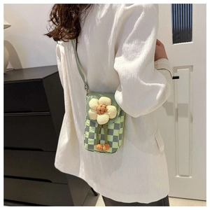 Detail of light green checkered crossbody bag with large 3D fabric flower decor