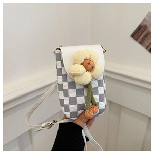 Close-up of checkerboard fabric phone bag featuring a 3D yellow floral accent and strap