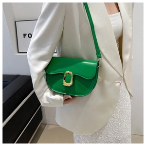 Detail of green semi-circular crossbody bag with large gold lock and matching slim strap