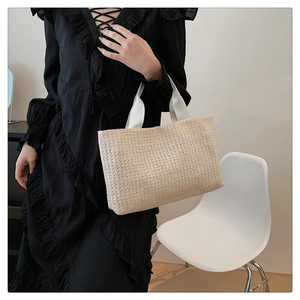 Detail of the woven texture and sturdy canvas handle on this large summer tote bag