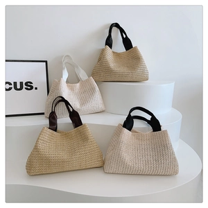 Set of four woven straw tote bags in neutral colors for spring and summer beach vacations