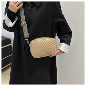 Minimalist khaki camera bag with quilted texture and ethnic patterned wide strap