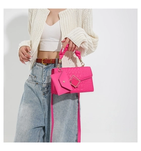 Detail of pink faux crocodile bag with pleated cloud handle and matching mini pouch
