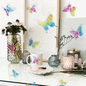 Detailed view of 3D laser holographic butterfly stickers on white home decor frames