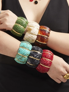 Macro shot of colorful resin stretch bracelets with gold-plated geometric textures