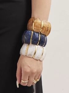 Detail of colorful resin stretch bracelets with gold-plated stainless steel spacers