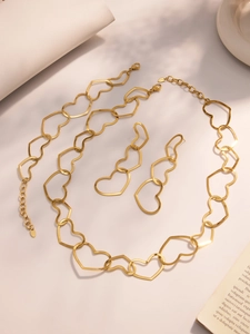 Detailed close-up of golden stainless steel hollow heart necklace and earrings set