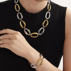 Two-tone oval link chain jewelry set including necklace, bracelet and beaded ring on model