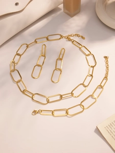 Détails d'un ensemble de bijoux en acier inoxydable doré avec fermoirs et tags S.Steel