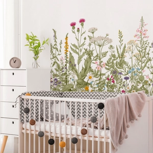 Floral wall stickers featuring thistle and daisies above a crib in a cozy nursery room