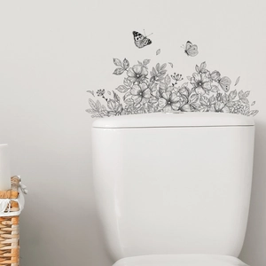 Floral line art wall decal with butterflies applied above a toilet tank in bathroom decor
