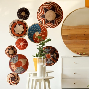 Set of 9 woven wall baskets with tribal star patterns in a boho living room setting