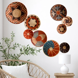 Detail of nine bohemian woven seagrass wall baskets with tribal geometric patterns
