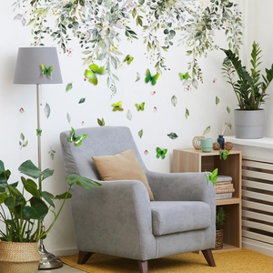 Detail of 3D green butterflies and vine wall stickers on furniture in Nordic living room