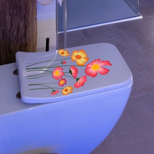 Floral wall decal with pink and orange cosmos flowers on a modern white toilet lid
