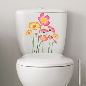 Floral wall decal with pink and orange cosmos flowers applied on a white toilet tank