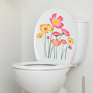 Colorful floral wall stickers with pink and yellow daisies on a white ceramic toilet lid