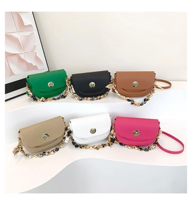 Detailed collection of colorful saddle bags with gold twist locks and silk scarf chains