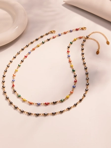 Detail of colorful Evil Eye necklaces with gold chains and adjustable lobster clasps