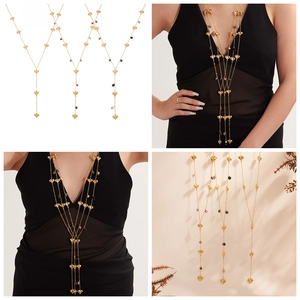 Detailed view of long gold layered heart necklace with colorful beads on black dress